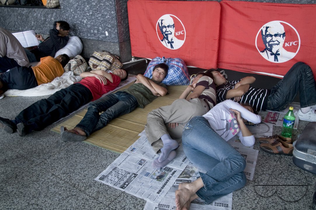 CHINA Migrant workers from the countryside waiting outside Guangzhou train station, Guangdong province.