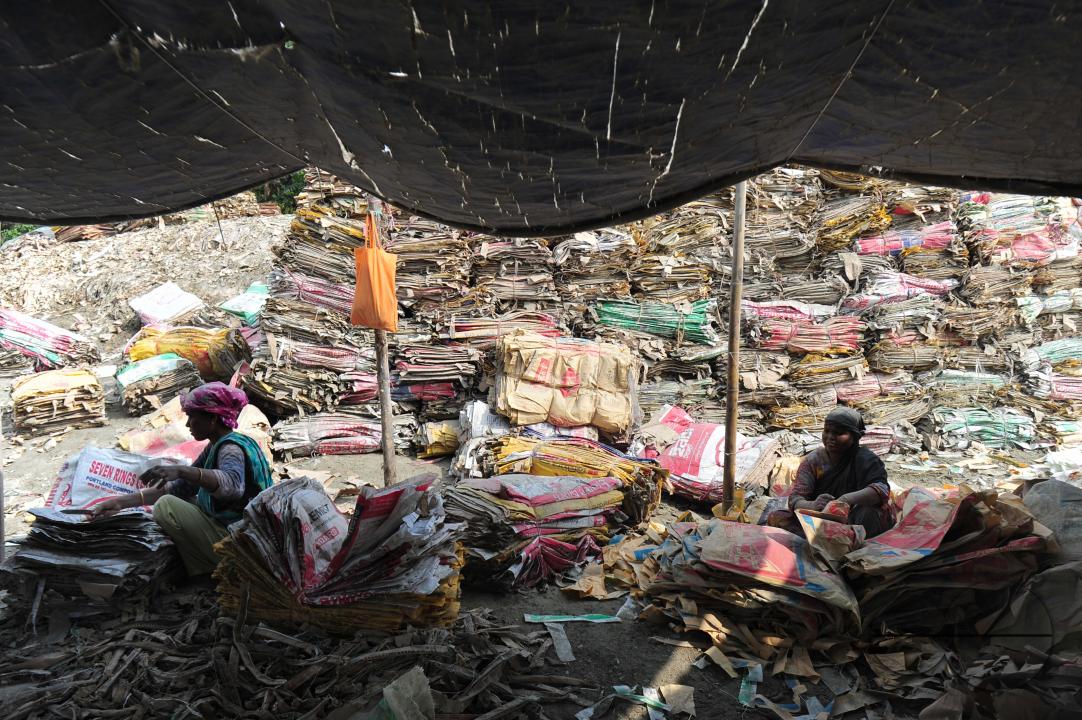 Women are risking their lives to wash cement bags beside the Surma River in Sylhet