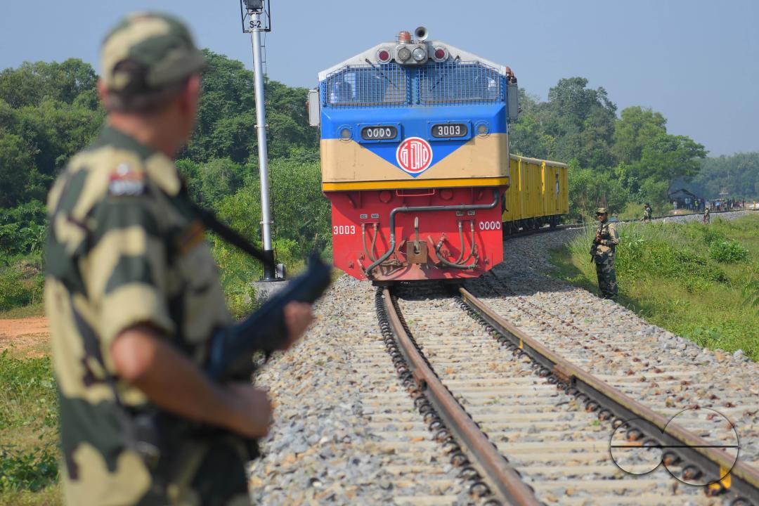 Indian people looking at a trial train and taking photographs, which is crossing the Indo-Bangladesh border