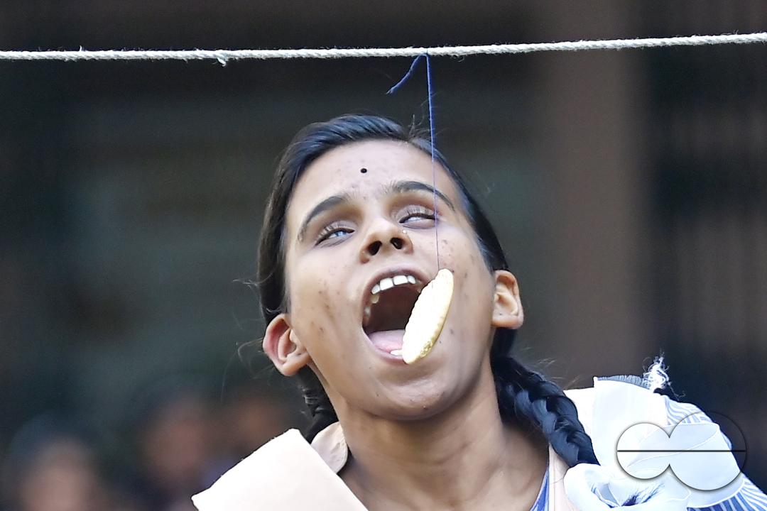 A student at the Institute for Visually Handicapped is participating in a 'Biscuit Race' during the 'Children's Day' celebration at the institute's campus in Narsingarh, in Agartala
