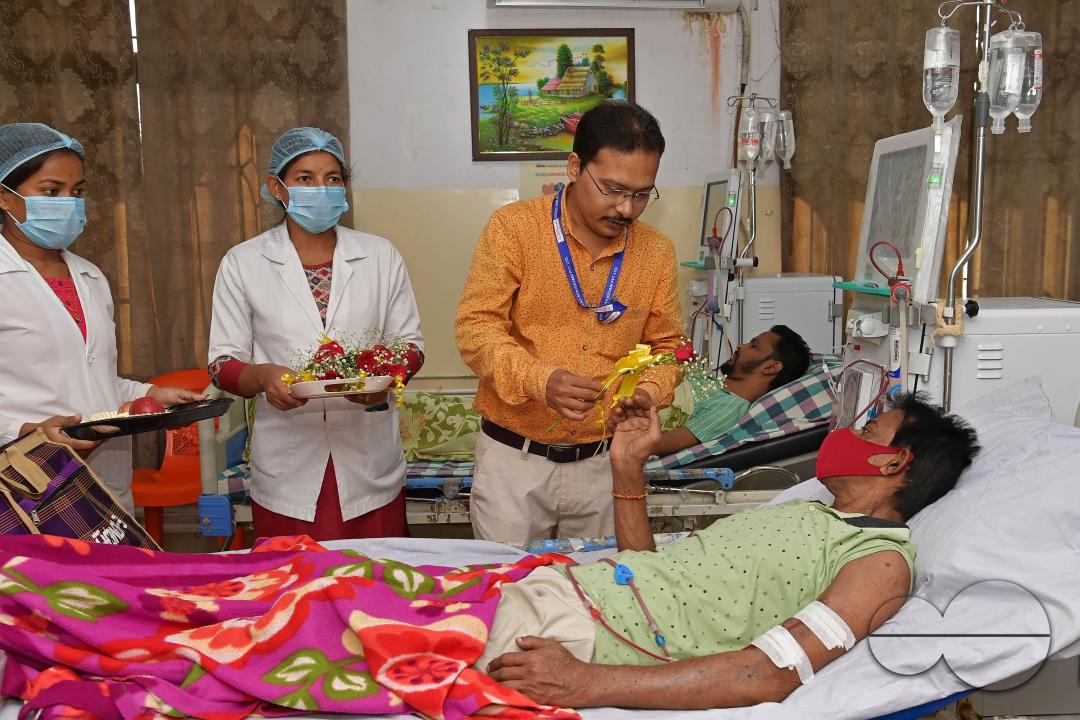 Doctors, along with health workers, distribute roses and fruits during the celebration of World Kindness Day in the dialysis ward at IGM (Indira Gandhi Memorial) Hospital in Agartala