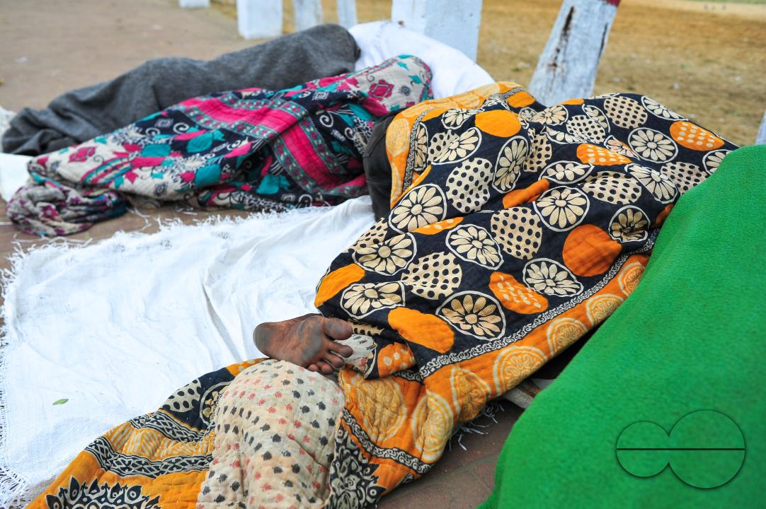 Covering their bodies from head to toe with whatever they can manage, homeless people sleep out in the open in the shivering cold near the Government Alia Madrasa in Sylhet city's Chowhatta area