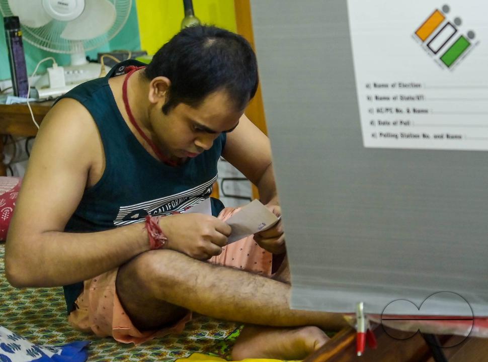 A differently abled boy casting his postal ballot vote at his house in front of the team of election officials and security personnel in Agartala
