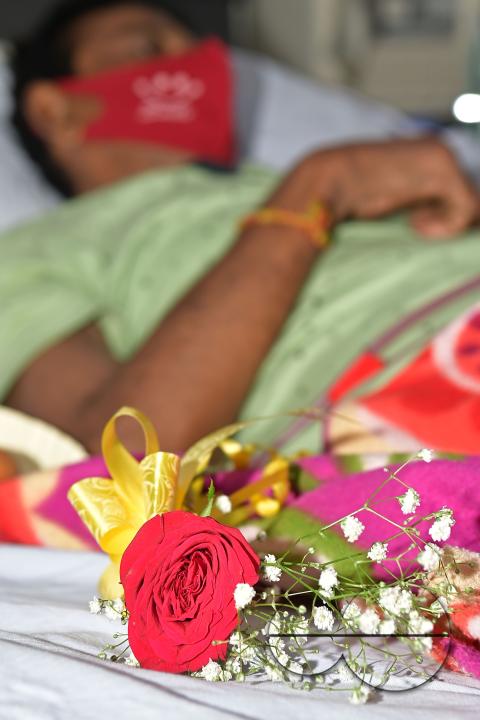 A rose and fruits are distributed to a patient by doctors and health workers during the celebration of World Kindness Day in the dialysis ward at IGM (Indira Gandhi Memorial) Hospital in Agartala