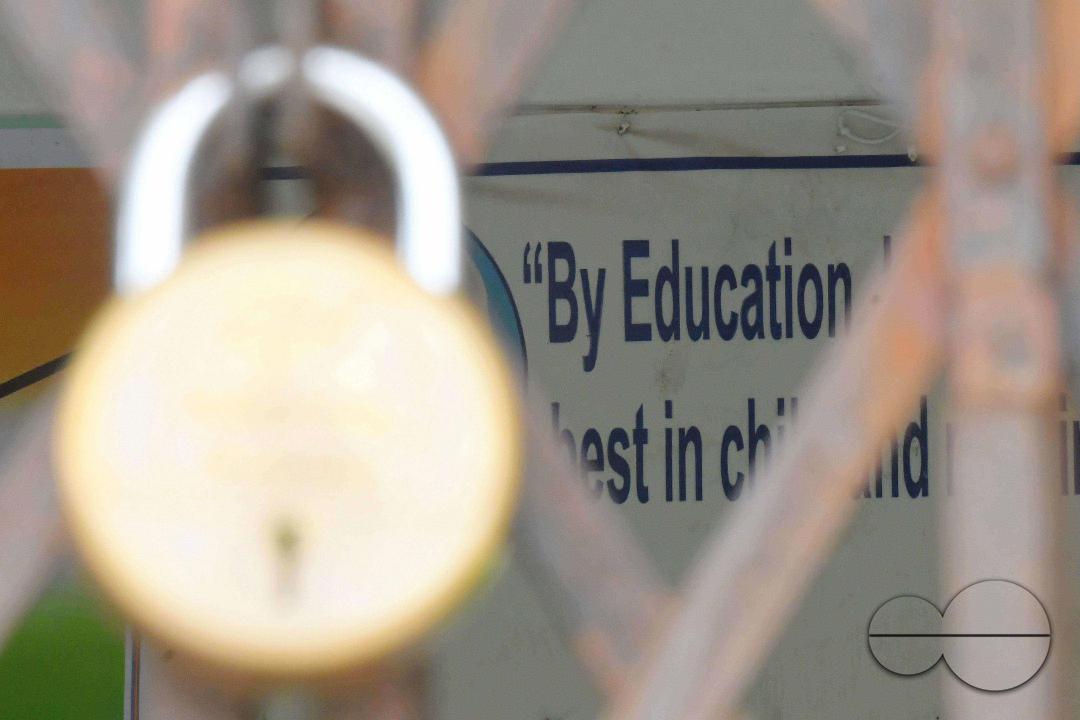 A locked gate of a government school during cyclone MidhiliÂ in Agartala