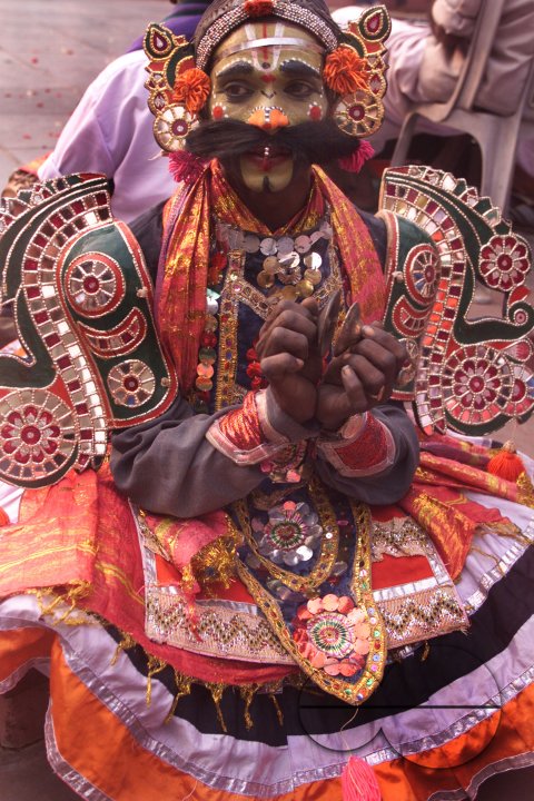 A South Indian dancer plays an instrument during a stage show at a dance festival in Kolkata