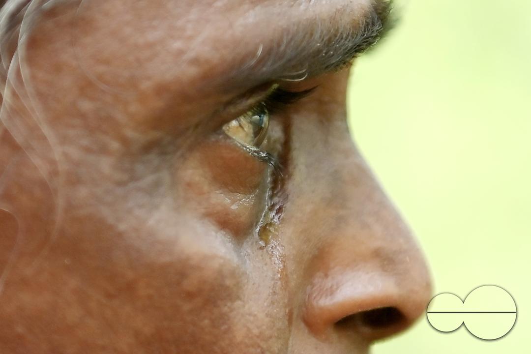 An elderly woman is crying in front of local MLAS officials at her makeshift tent at the Panisagar's reserve forest