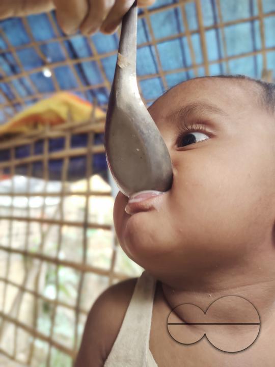 A child been fed soup at the Balukhali refugee camp