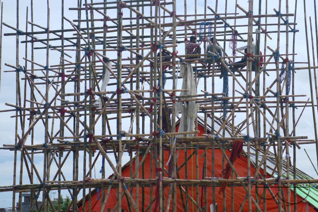 Workers are making a temporary bamboo structure, locally called "Pandal", for the upcoming Durga Puja in Agartala