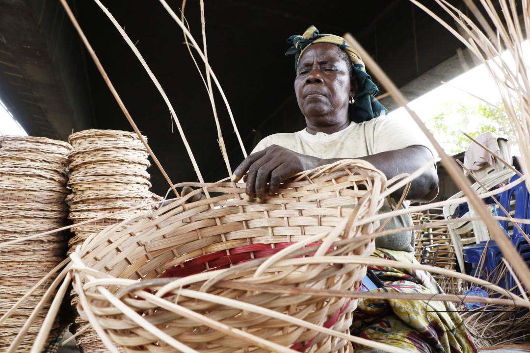 A woman weaves a household basket at Nigeria's largest cane 'village' at Mende in the Maryland District of Lagos