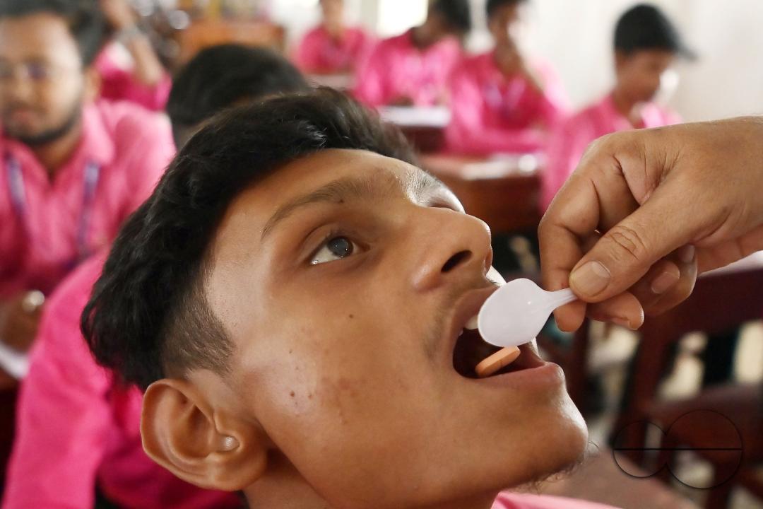 A student of Netaji Subhash Vidyaniketan High School is taking a deworming tablet during the special program "Mukhyamantri Sustho Shoishob, Sustho Kaishore Abhiyan (MSSSKA 7.0)" in Agartala