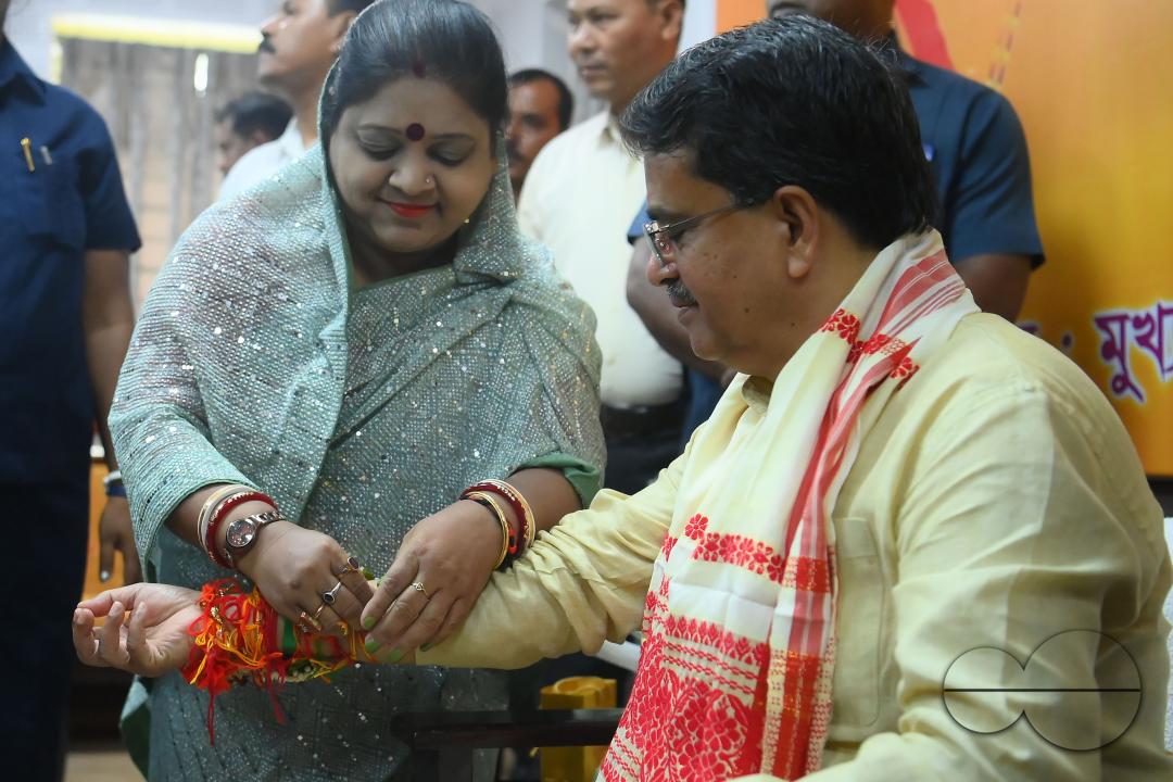 A lady tying rakhi and doing other rituals to Tripura CM Professor Dr