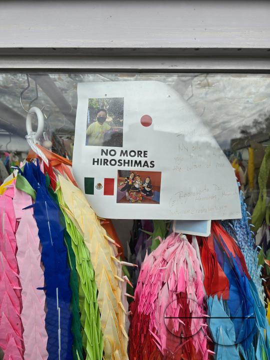Multicoloured paper ribbons, woven by children and other visitors, are tied to the railings of the Peace Memorial Park Center, as a symbol of love and harmony