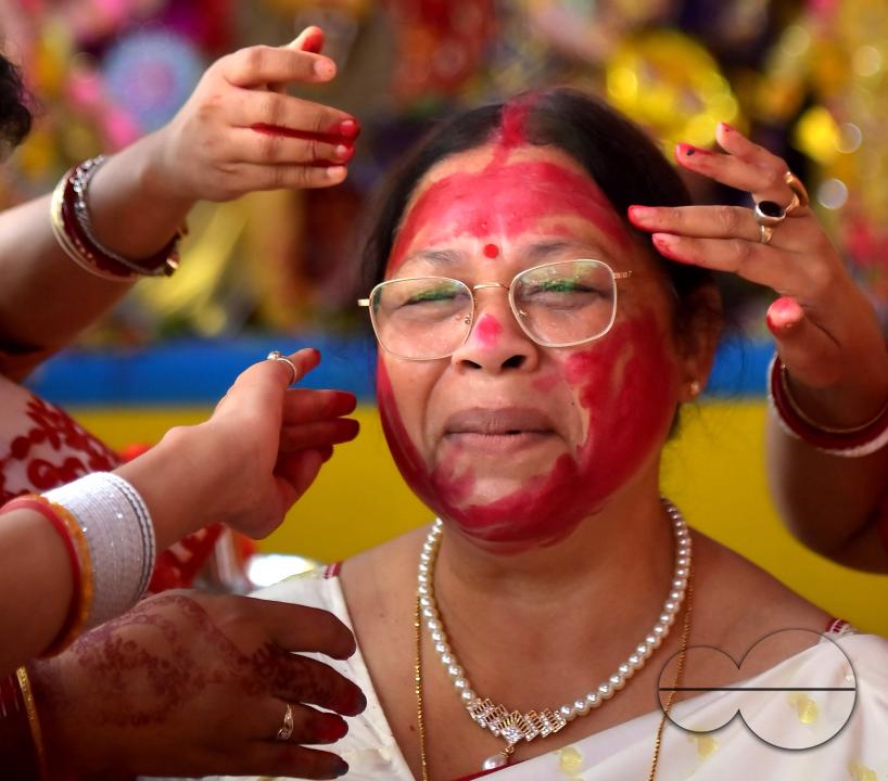 Married women smear each other with vermillion during a ritual called the vermillion game, or "Sindur Khela," on the last day of the Durga Puja festival in Agartala, Tripura, India.
