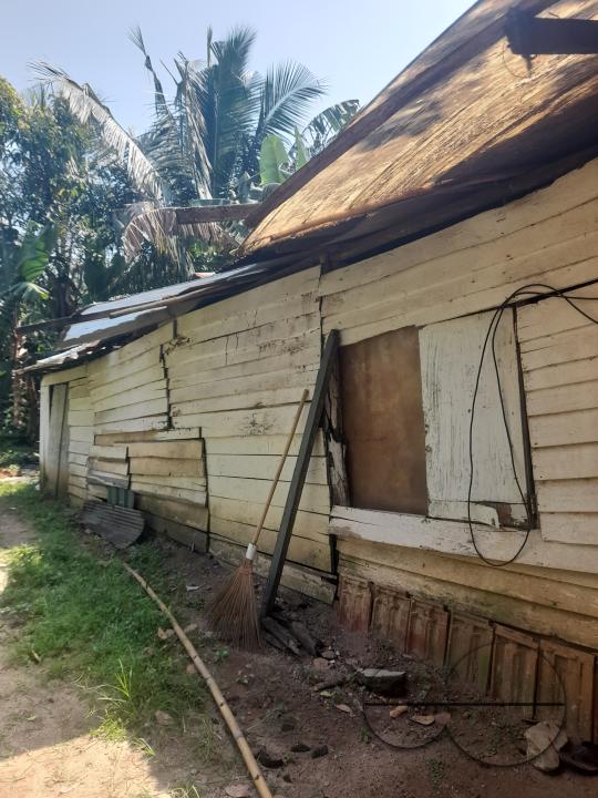 A poor family lives in a plank house on the verge of collapsing. Colombo, Sri Lanka.