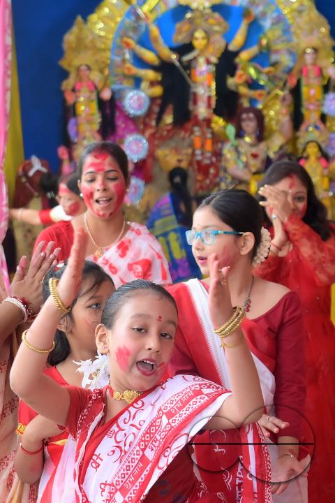 Children and married women are dancing, and the women smear each other with vermillion during a ritual called the vermillion game, or "Sindur Khela," on the last day of the Durga Puja festival in Agartala, Tripura, India.