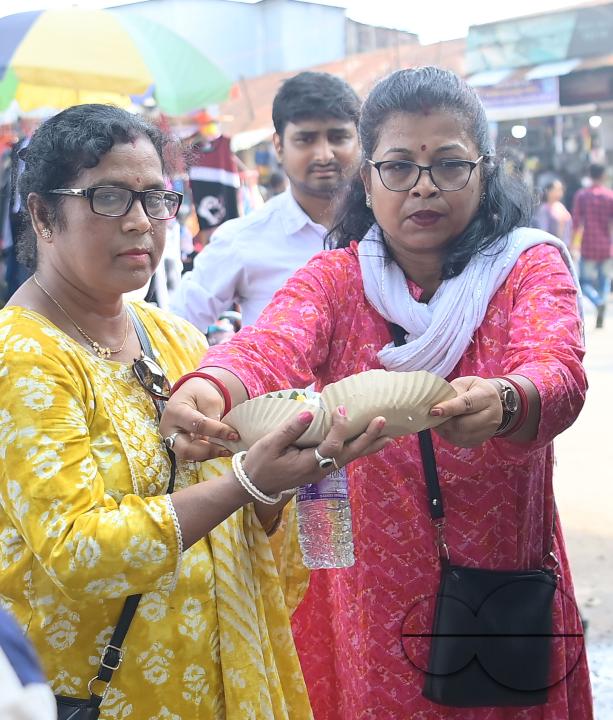 People get food from a social worker on World Food Safety Day, organised by Rotary Club of Agartala, in Agartala