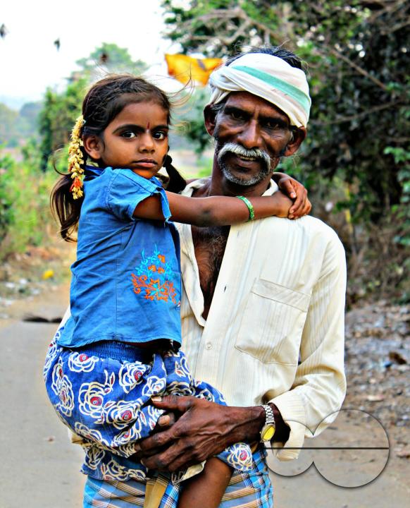 Portrait of a Indian farmer and child during a hard day's work at a rural village