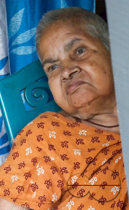 An old lady aged 104, going through the pre vote procedures before casting her postal ballot vote with the assistance of her family members at her house in front of the team of election officials and security personnel in Agartala