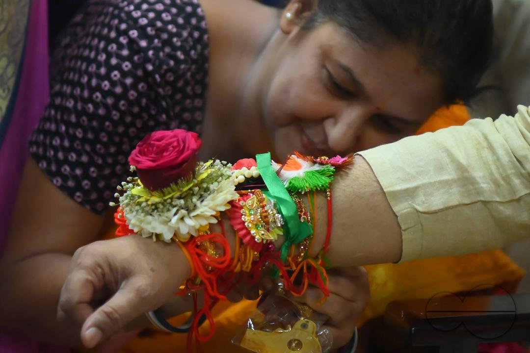 A lady tying rakhi and doing other rituals to Tripura CM Professor Dr