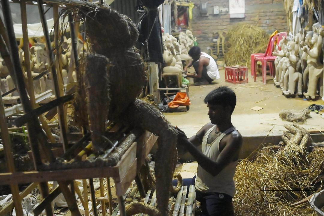 An Idol maker making idols of Lord Ganesh in a studio for the upcoming Ganesh Chaturthi festival at Agartala