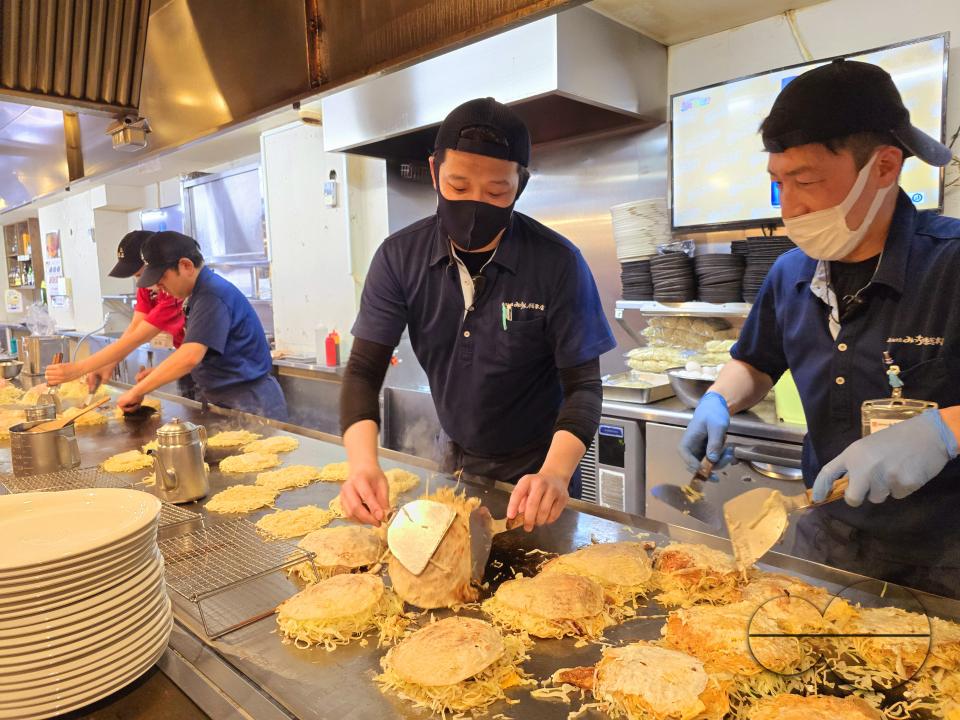 Chefs preparing Okonomiyaki, known as Hiroshimaâs soul food and served in some 2,000 restaurants in and around the city