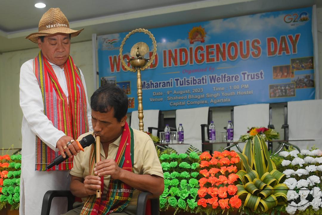 An indigenous blind musician playing the flute on the occasion of World Indigenous Day at an auditorium in Agartala