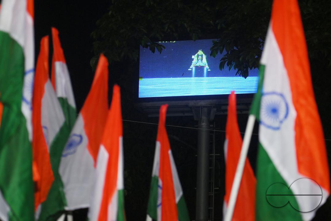 BJP party leaders, workers and the general public celebrate with the Indian flag in front of a LCD TV during the live stream of the successful lunar landing of the Chandrayaan-3 spacecraft on the south pole of the Moon, in Agartala