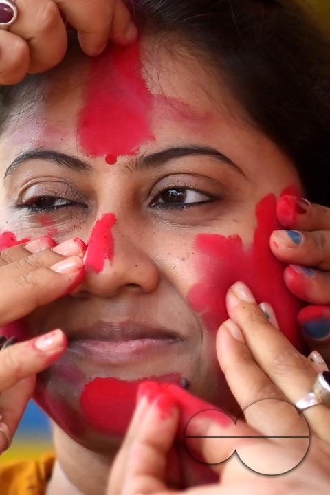 Married women smear each other with vermillion during a ritual called the vermillion game, or "Sindur Khela," on the last day of the Durga Puja festival in Agartala, Tripura, India.