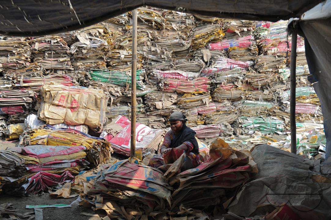 Women are risking their lives to wash cement bags beside the Surma River in Sylhet