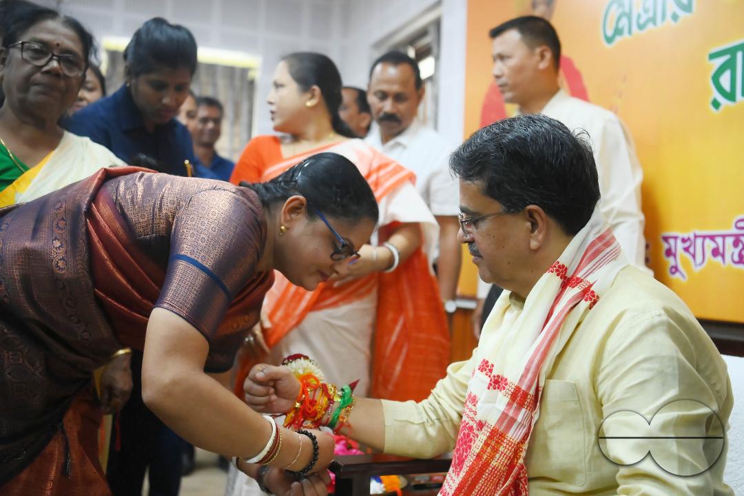 A lady tying rakhi and doing other rituals to Tripura CM Professor Dr