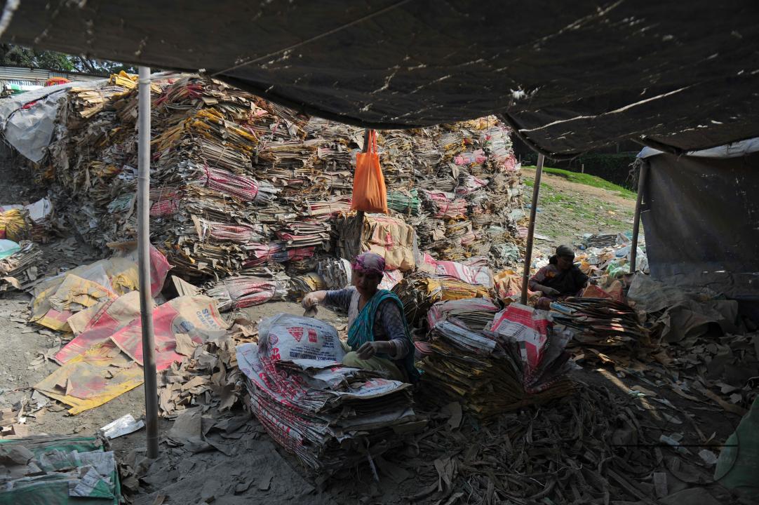 Women are risking their lives to wash cement bags beside the Surma River in Sylhet