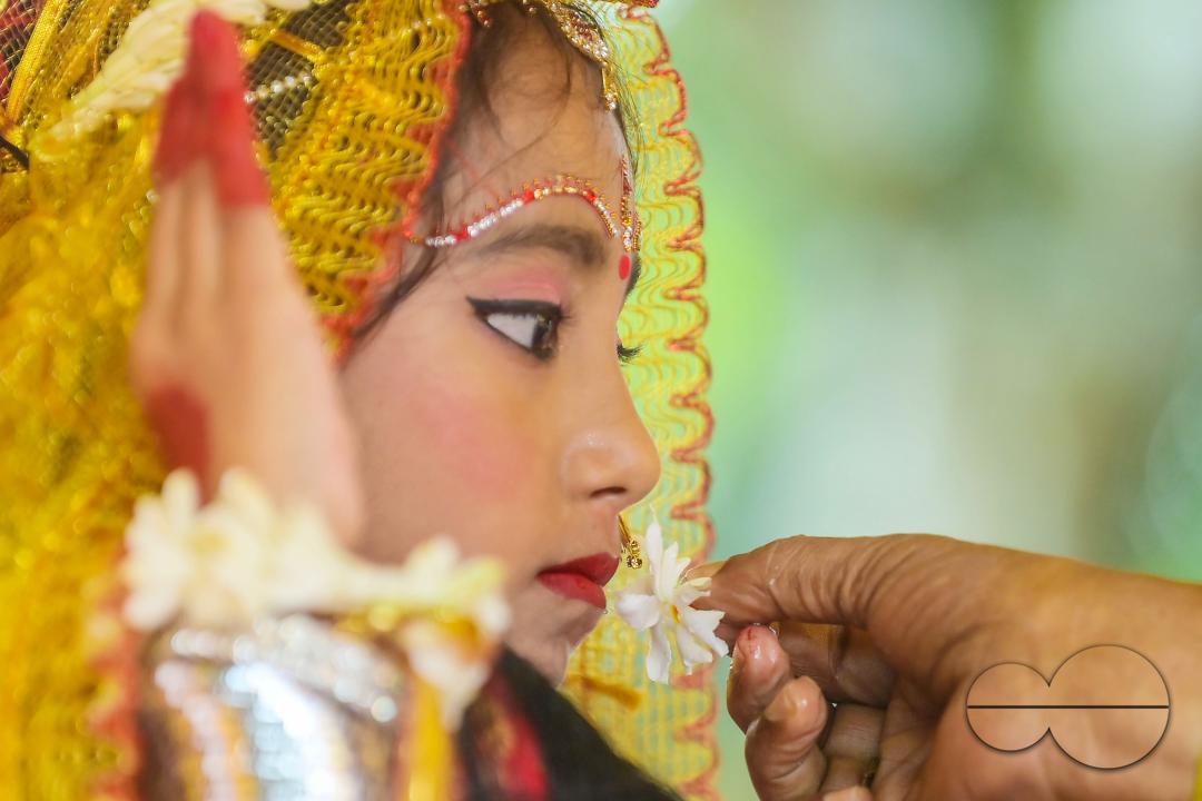 Priests worship a nine-year, five-month, and fourteen-day-old Hindu girl, Debalina Chakraborty, known as a "Kumari," who yawns during the Durga Puja religious festival at the Ramakrishna Vivekananda Ashram, operated by the Ramakrishna Mission on the outs