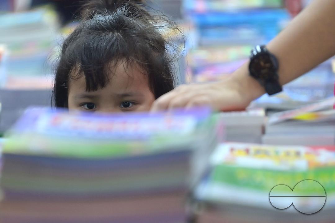 Children looking at books in a book stall at the 42nd Agartala Book fair International Fair Ground, Hapania at Agartala