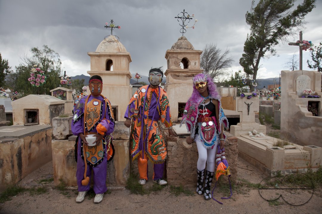 Young people in traditional costumes at a cemetery during Carnival in Humahuaca,  Jujuy province in the Andes region of Argentina, South America