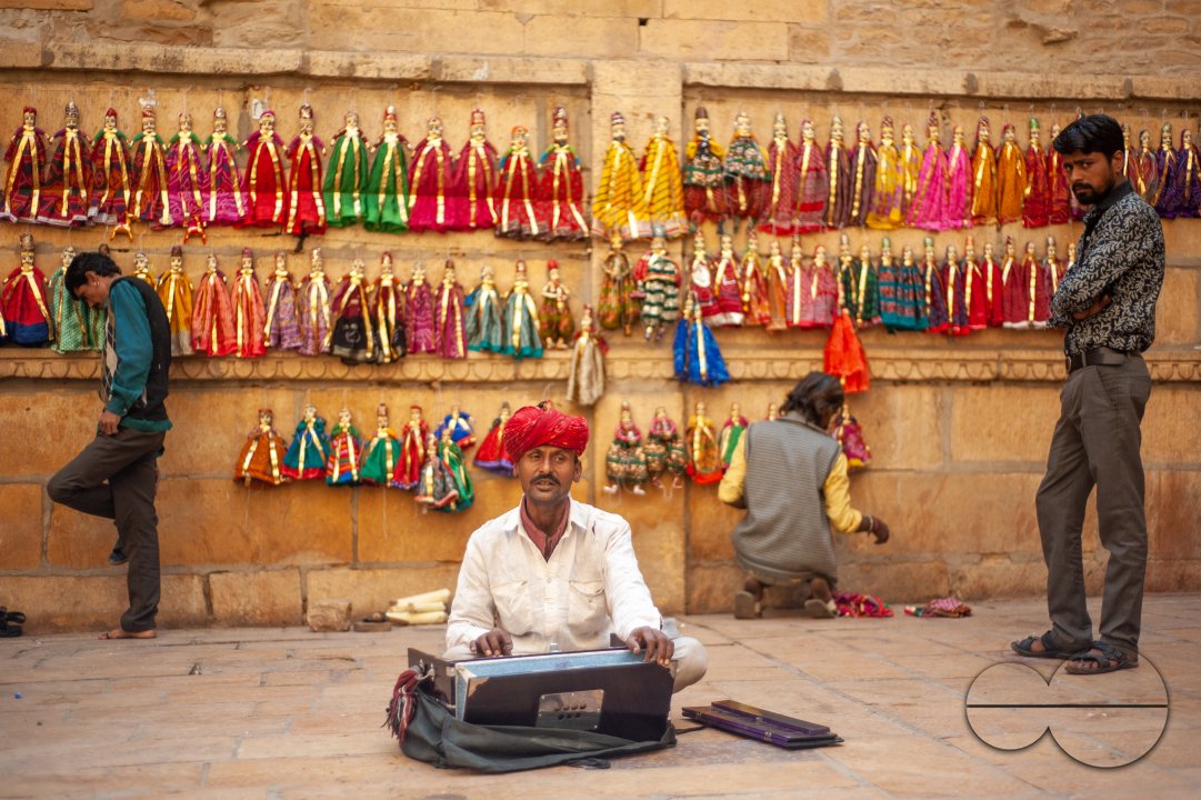 A Rajasthani musician singing and playing the Tanpura in a market area in Jaisalmer.