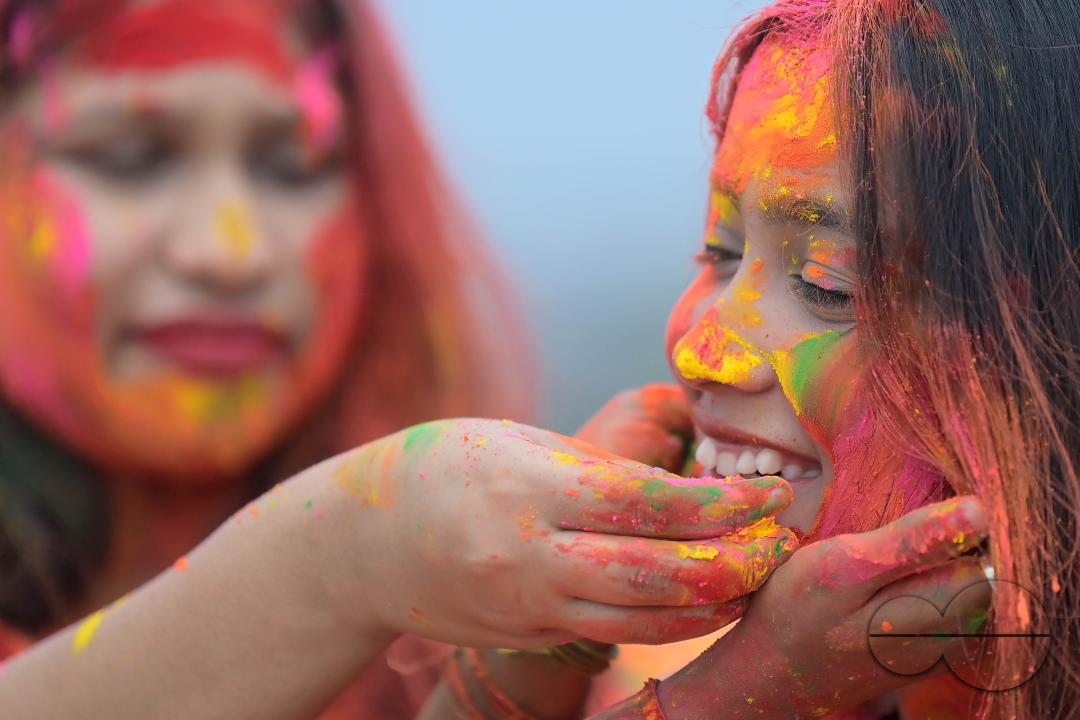 Indian girls adorned with 'Gulal' or coloured powder during the Hindu spring festival 'Holi', the festival of colour in Agartala