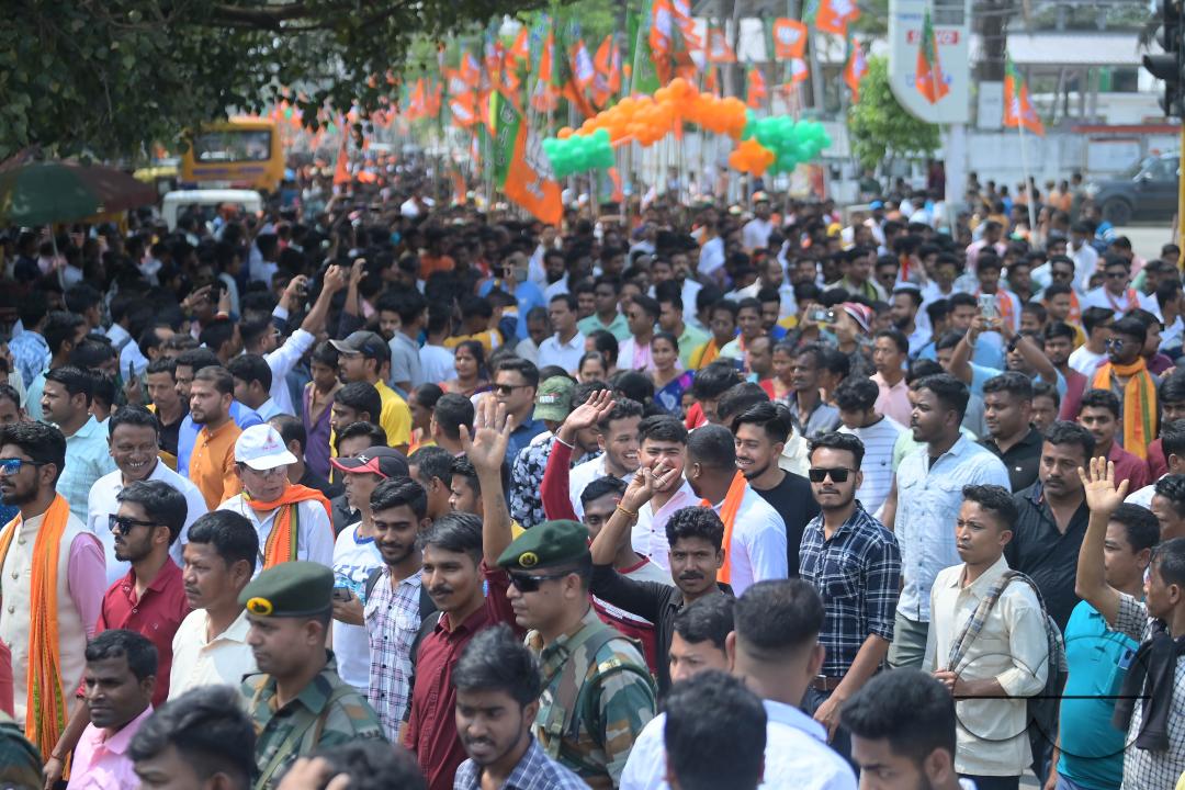 BJP supporters seen in a rally with Tripura Chief Minister Manik Saha, former CM and BJP candidate Biplab Kumar Deb, and Kriti Singh along with other leaders during an election campaign rally in support of Lok Sabha candidates at Agartala
