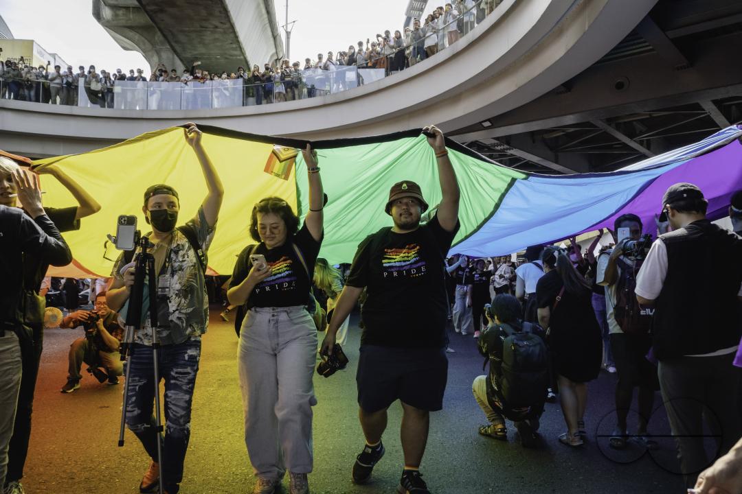Participants at the Bangkok Pride Parade 2023 are carrying a giant rainbow flag at Pathumwan Intersection in Bangkok, Thailand.