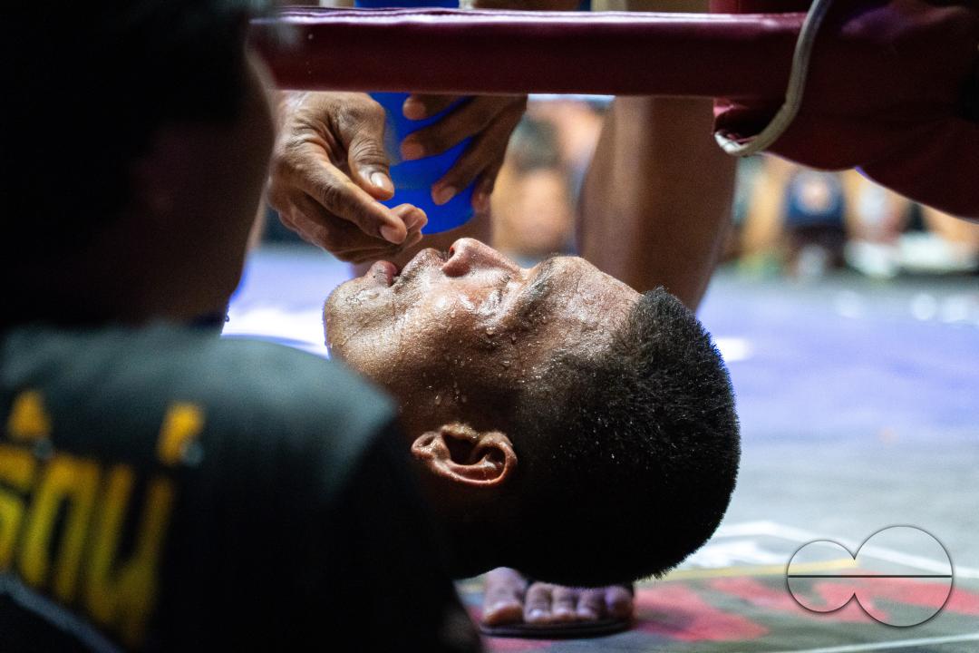 A doctor is removing the mouthguard from Thai boxer Petch Si Nel, after he was knocked out during the Muay Thai Fights, on Koh Chang Island, Thailand.