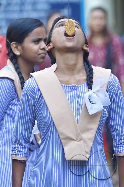 A student at the Institute for Visually Handicapped is participating in a 'Biscuit Race' during the 'Children's Day' celebration at the institute's campus in Narsingarh, in Agartala