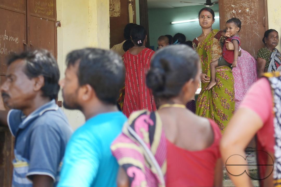 Flood victims are queuing up during a health check-up at a temporary relief camp
