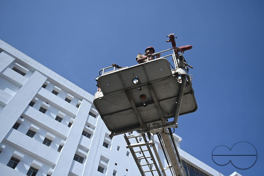 Fire brigade personnel are trying to control a fire on the top of the building of the dental college during a state level mock exercise on earthquake day at Agartala