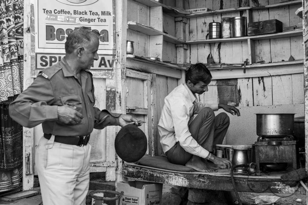 A security guard buying from a chai stall in the golden fort, Jaisalmer.