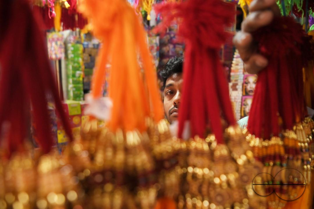 A shop owner arranging "Rakhi", sacred threads for the upcoming "Raksha Bandhan" festival at his shop in Agartala