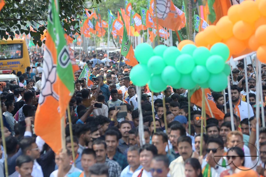 BJP supporters seen in a rally with Tripura Chief Minister Manik Saha, former CM and BJP candidate Biplab Kumar Deb, and Kriti Singh along with other leaders during an election campaign rally in support of Lok Sabha candidates at Agartala