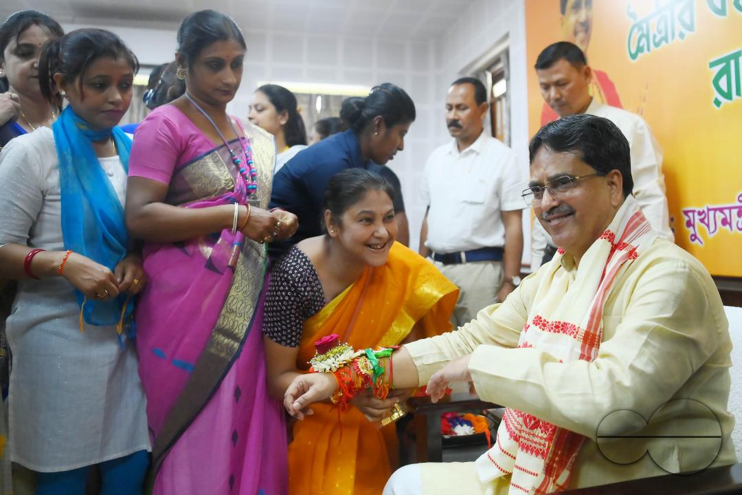 A lady tying rakhi and doing other rituals to Tripura CM Professor Dr