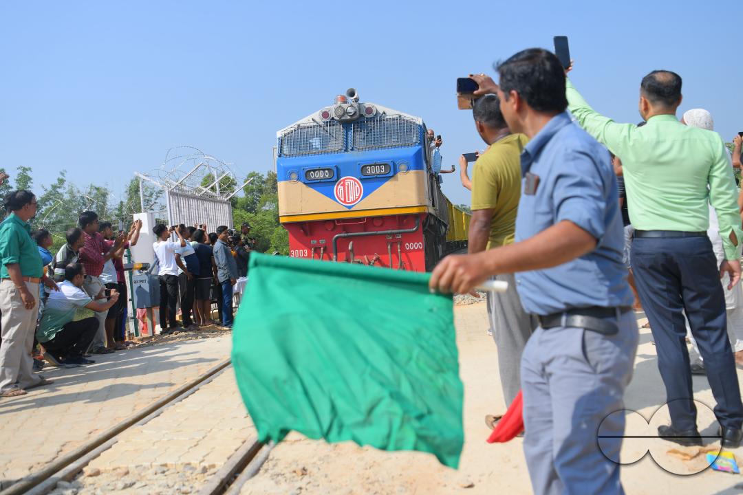 Indian people looking at a trial train and taking photographs, which is crossing the Indo-Bangladesh border