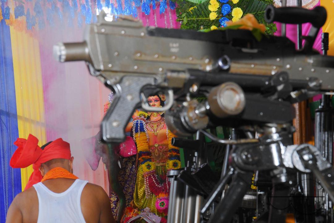 A priest performs worship of arms on Vishwakarma Puja in a TSR (Tripura State Rifles) camp on the outskirts of Agartala