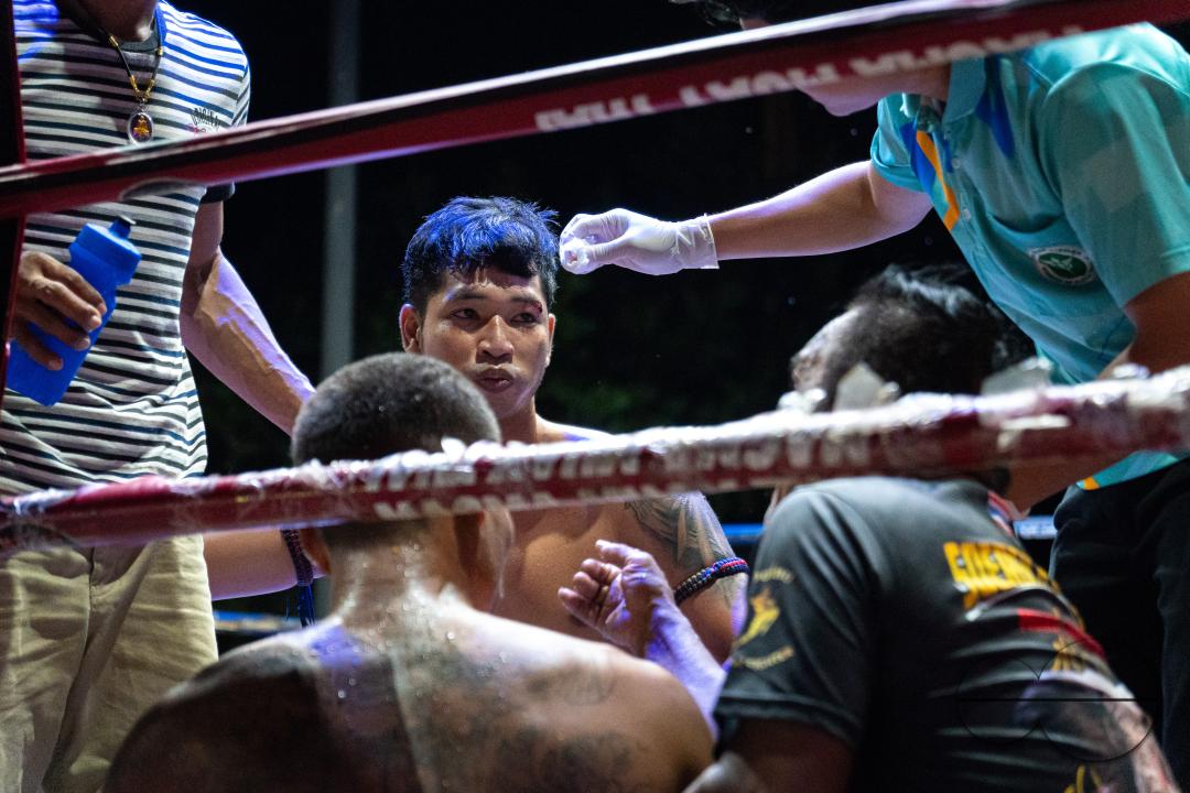 The winning boxer Frame Payak (C) is seen talking to the organizer while receiving treatment, during the Muay Thai Fights, on Koh Chang Island, Thailand.